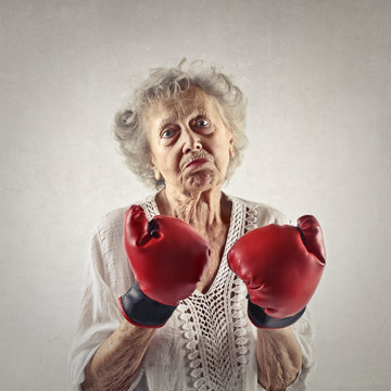 Elderly woman wearing boxing gloves