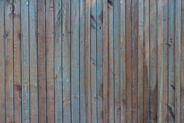 Old wooden fence texture with some dirty blue paint. Aged natural background, retro wall.