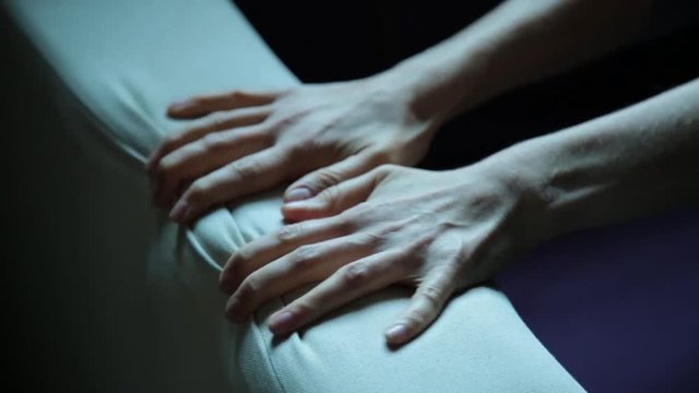close-up hands of a young woman lying on a bad. Girl crumples couch