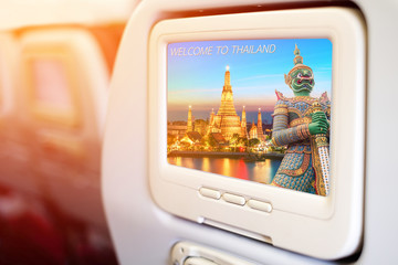 In-flight entertainment  showing a beautiful Wat Arun, the Temple of  Dawn in Thailand and a statue of Thai giant guardian on the screen
