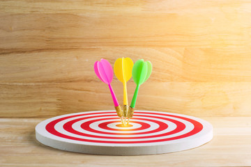 Fototapeta na wymiar target dart with arrow over wooden background ,abstract background to target marketing concept .