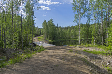 Wooden bridge on a forest dirt road