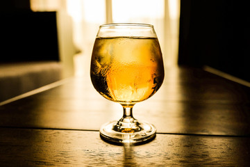 Glass of beer in a dark room