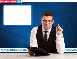 Television reporter telling breaking news at his studio desk wit
