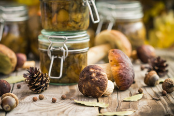 Marinated mushrooms jars wooden table