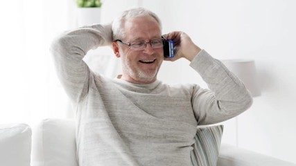 happy senior man calling on smartphone at home 99 - Powered by Adobe