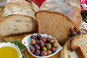 Traditional italian appetizer - fresh homemade bread, extra virgin olive oil and olives