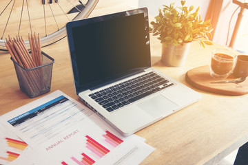 Fototapeta premium Working in office with Showing Hand Market Report Charts.Marketing Department Planning New Strategy.Researching Process Wood Table.Horizontal.Blurred Background.Film effect.