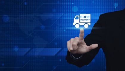 Businessman pressing free delivery truck icon over digital world