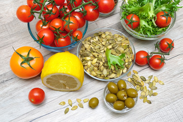 ingredients for preparation of vegetable salad on a wooden backg