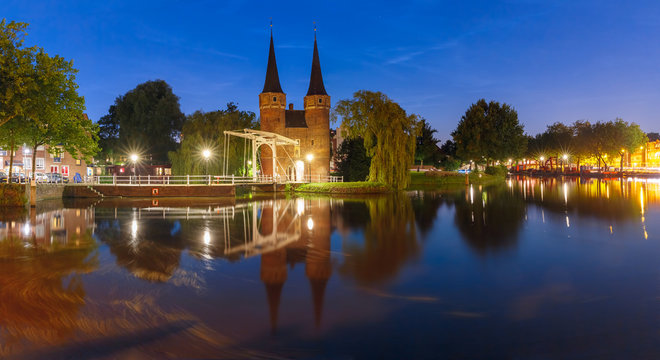 Eastern Gate, Oostpoort, with the white draw bridge, along Delftse Schie canal at night, Delft, Holland, Netherlands