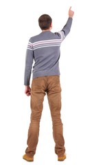 Back view of  pointing young men in  sweater and jeans. Young guy  gesture. Rear view people collection.  backside view of person.  Isolated over white background.