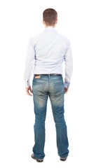 Back view of man in jeans. Standing young guy. Rear view people collection.  backside view of person.  Isolated over white background. Business man in shirt and jeans is looking ahead.