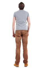 Back view of handsome man in shirt and jeans  looking up.   Standing young guy. Rear view people collection.  backside view of person.  Isolated over white background.