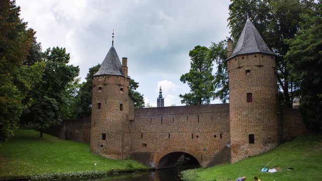 Boat passing a historic medieval city gate in Amersfoort, the Netherlands, 4K time lapse