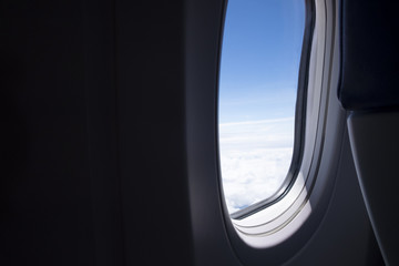 Fototapeta premium Airplane red seat and window inside an aircraft