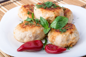 Meatballs of minced chicken with red pepper and green basil