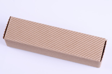 Small carton box on white background. Selective focus.