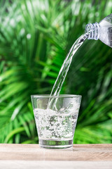 Glass of water on nature background.