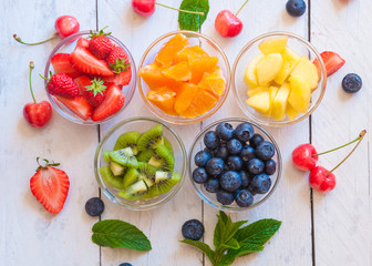 Ingredients for a fruit salad of rainbow colors