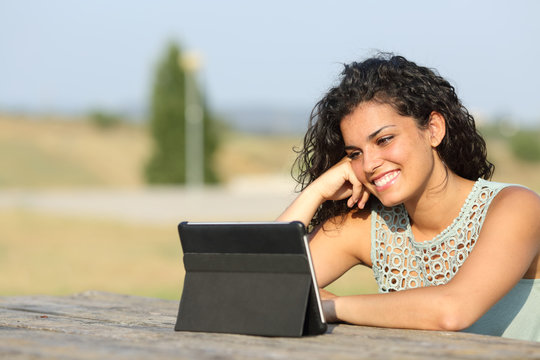 Girl Watching Video On A Tablet Outdoors