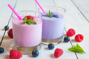 Two glasses of milkshake with fresh berries