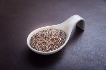 Healthy and Nutritious Chia Seeds in White Bowl on a Brown Backg
