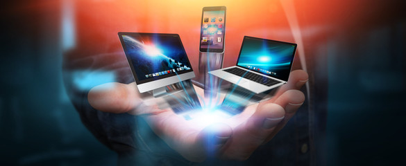 Tech devices and icons connected to businessman hand