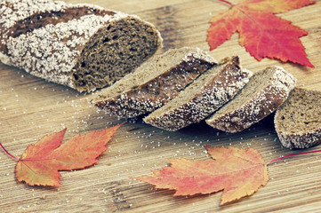 Sliced bread lying on the table decorated with colorful maple leaves