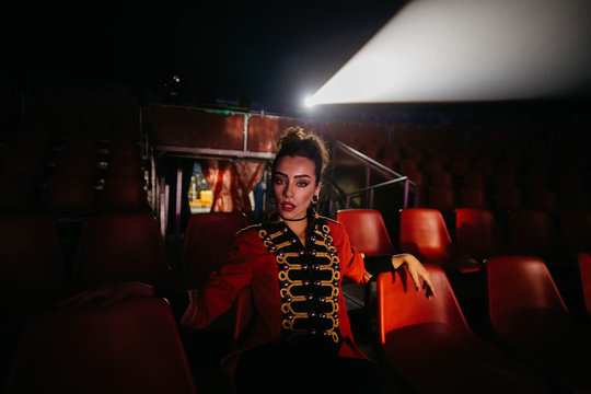 Woman with defiant makeup posing in cinema hall