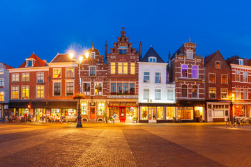 Fototapeta na wymiar Typical Dutch houses on the Markt square in the center of the old city at night, Delft, Holland, Netherlands