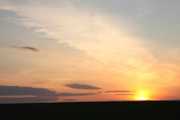 Sunset sky background. Beautiful sky. Landscape. Sunny sunset in a field.