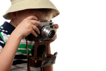 Little boy shooting on the vintage photo camera