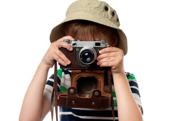 Little boy shooting on the vintage photo camera