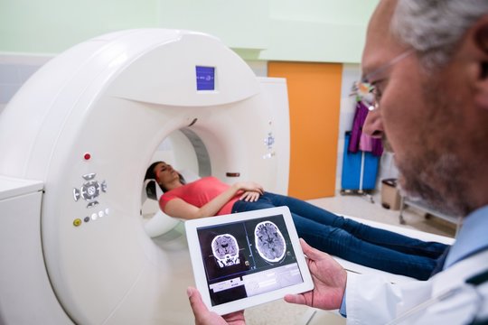 Doctor looking at brain mri scan on digital tablet