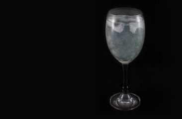 Aloe vera juice in glass isolated on black background.