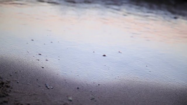 Heart drawn jn beach sand washed away by waves