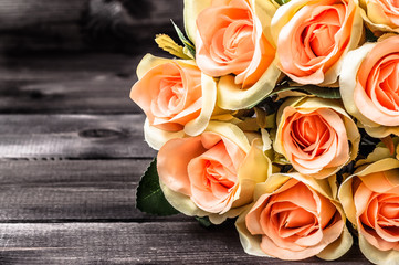 Pink roses on wooden background