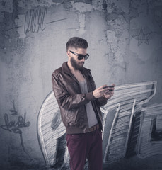 Fashion model standing at graffiti wall