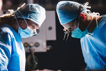 Surgeons performing operation in operation room