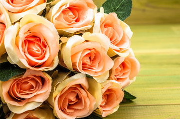 Pink roses bouquet on wooden table