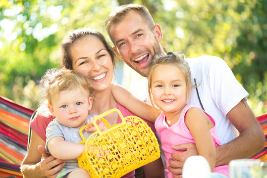 Happy joyful young family with little children outdoors