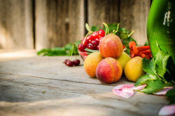 Still life of summer fruits. orange peaches, red cherries and gr