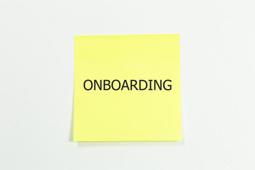 Onboarding word written on yellow sticky notes. isolated on white