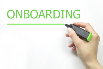 Hand writing Onboarding with marker on transparent wipe board isolated on white.