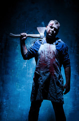 Bloody Halloween theme: crazy killer as butcher with an ax