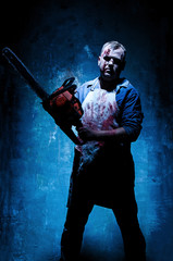 Bloody Halloween theme: crazy killer as butcher with electric saw