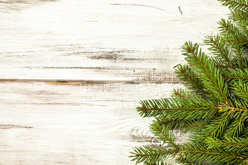 Green spruce branch, christmas backgrounds on white table
