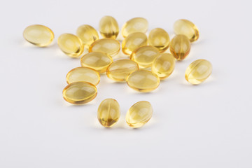 Fish oil capsules on the white