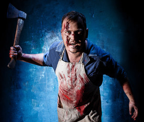 Bloody Halloween theme: crazy killer as butcher with an ax